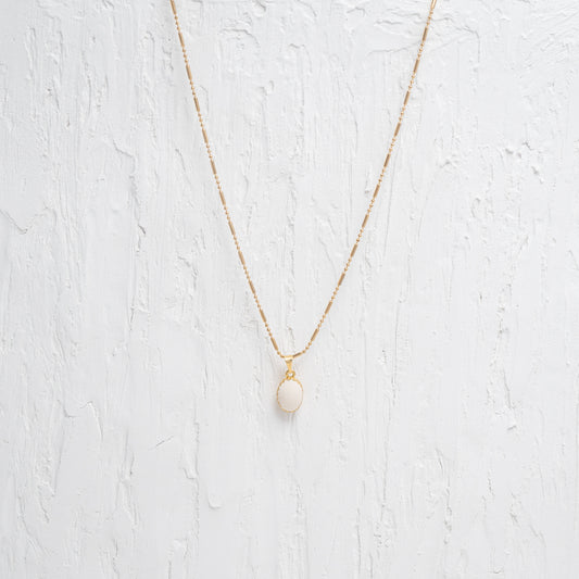 Elegant white oval charm necklace on a delicate chain, showcasing a lustrous pendant for a touch of sophistication.