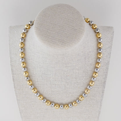 Detailed shot of the Two-Tone Beaded Necklace’s clasp, emphasizing the seamless blend of gold and silver.