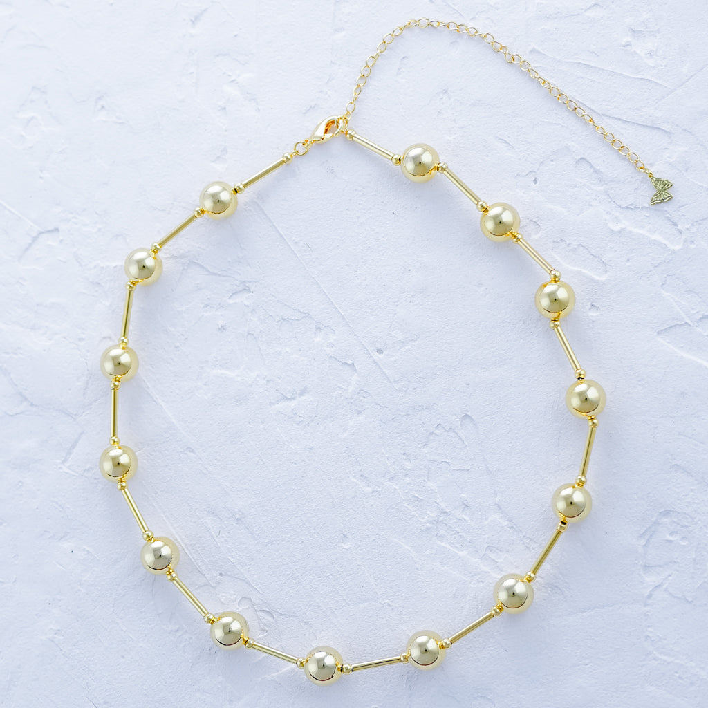 Gold ball and bar necklace