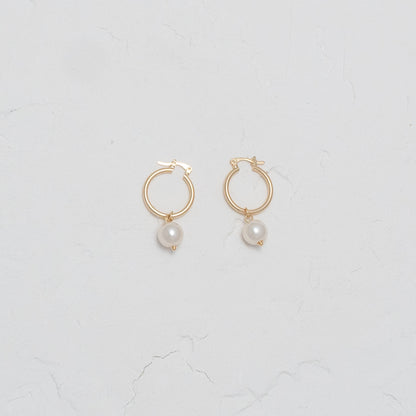 Elegant Pearl and Gold Dangle Hoops, showcasing timeless elegance with a modern twist.