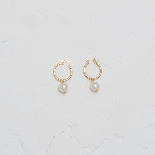 Elegant Pearl and Gold Dangle Hoops, showcasing timeless elegance with a modern twist.