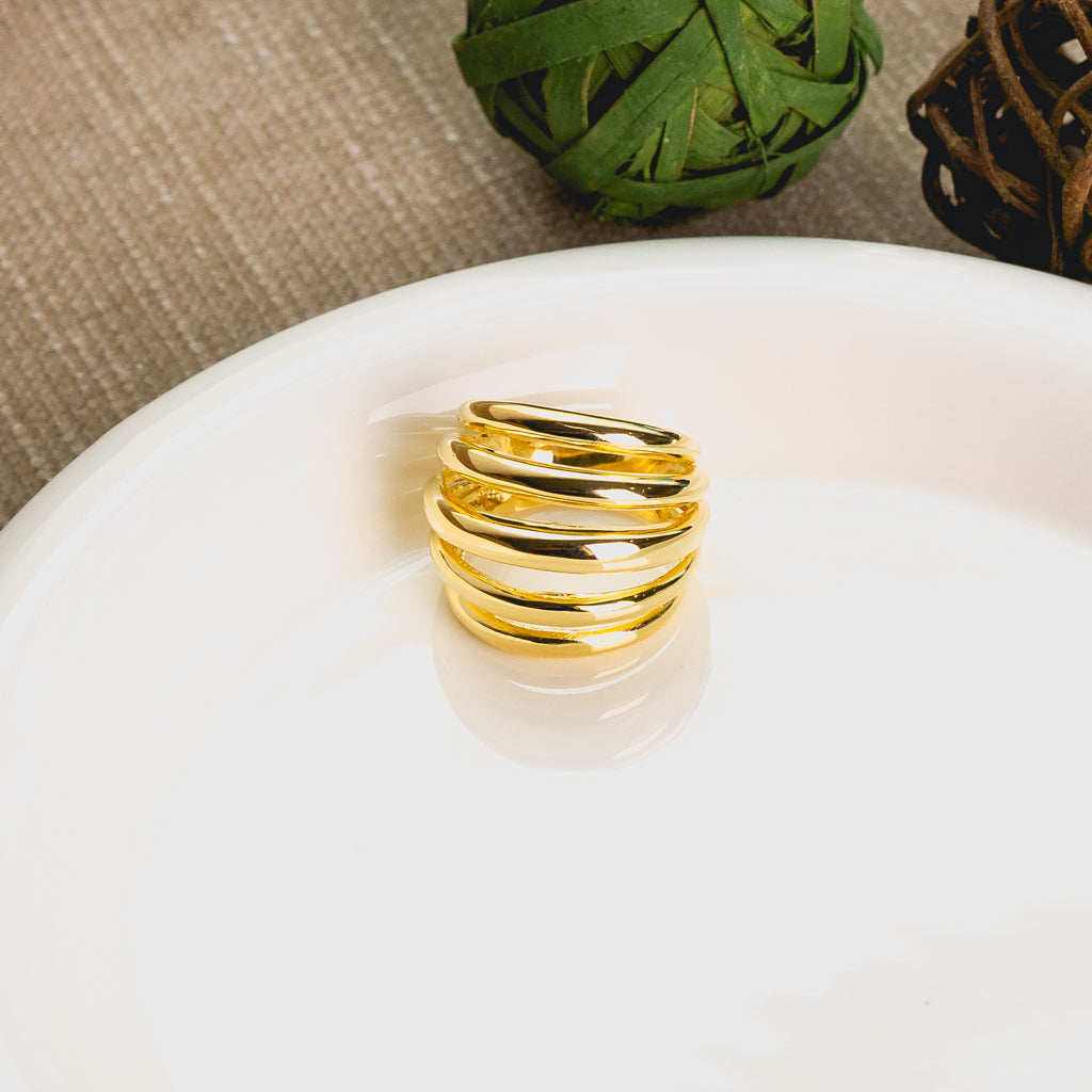 op view of Five Strand Ring against a simple backdrop, emphasizing its elegance