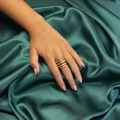 Angled view of a model's hand wearing the Five Strand Ring, capturing its unique design