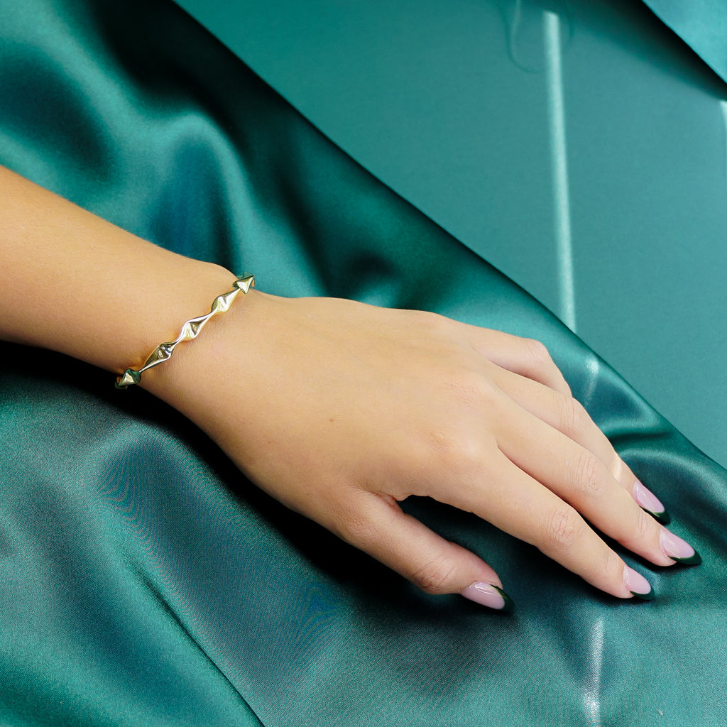 Model wearing Gold Dented Bangle, view is from the side.