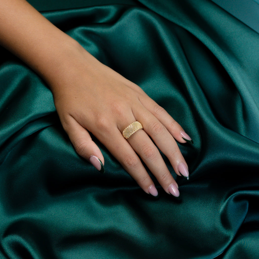 Angled view of model wearing the Gold Mesh Ring under soft lighting