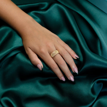 Angled view of model wearing the Gold Mesh Ring under soft lighting