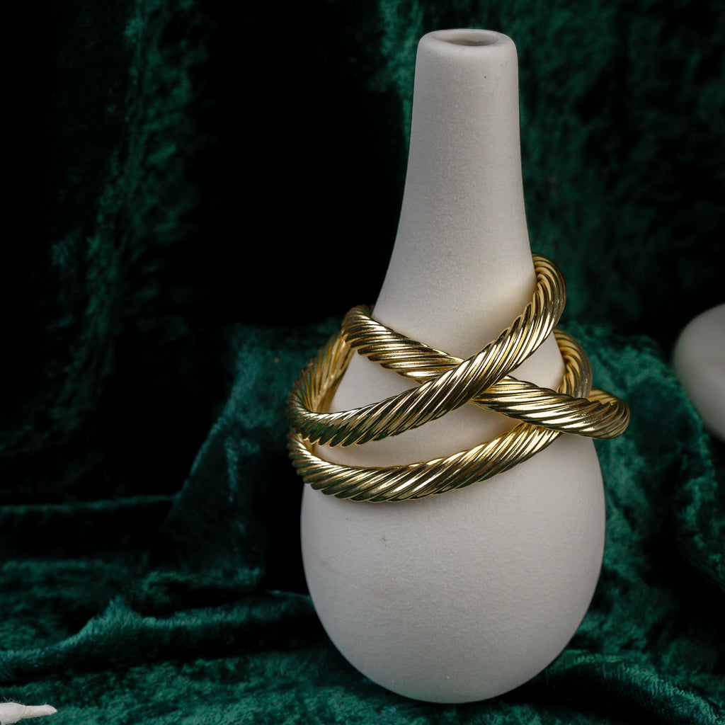 Close-up of three Twisted Gold Bangle showing  lines