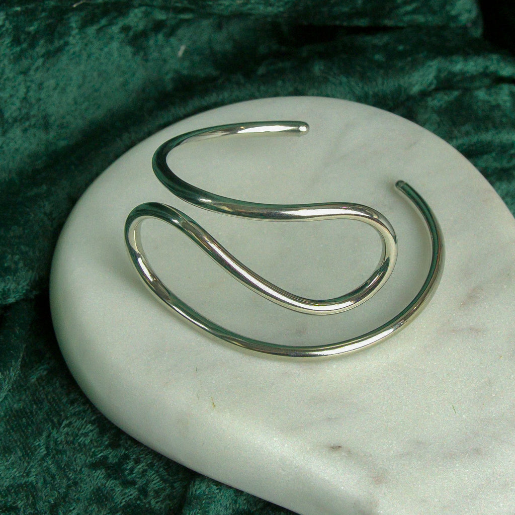 Side view of Modern silver Swirl Bangle showing the intricate swirl design