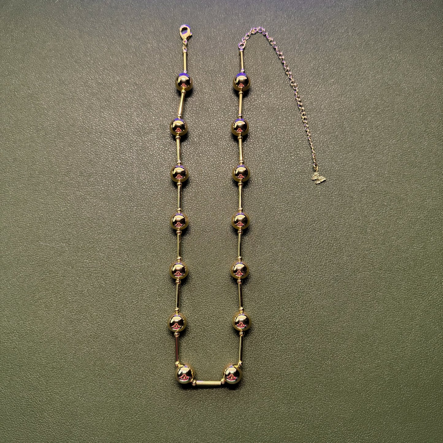 Gold ball and bar necklace