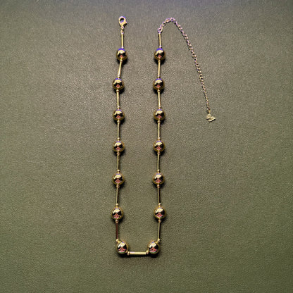 Gold ball and bar necklace